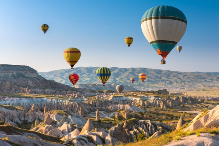 Hot air balloons over Cappadocia landscape