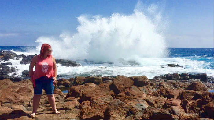Blogger On Rocks By Sea In Fuerteventura