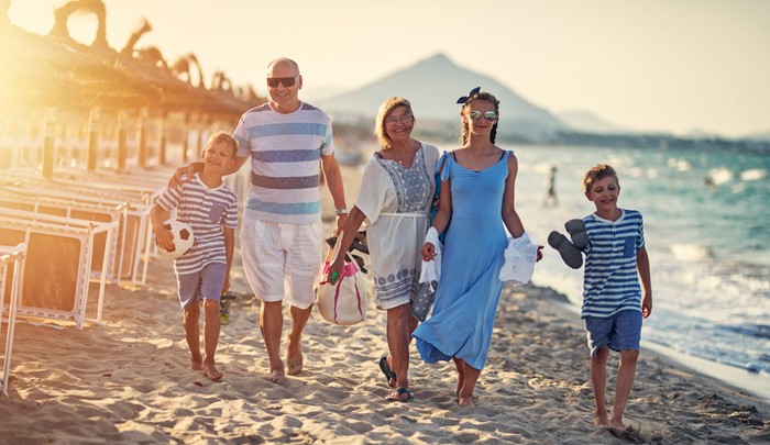 Family Walking On An Overseas Beach