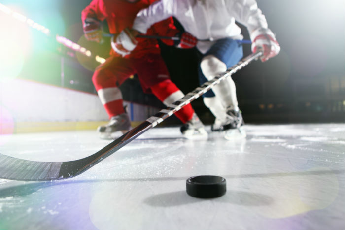 Two People Playing Ice Hockey