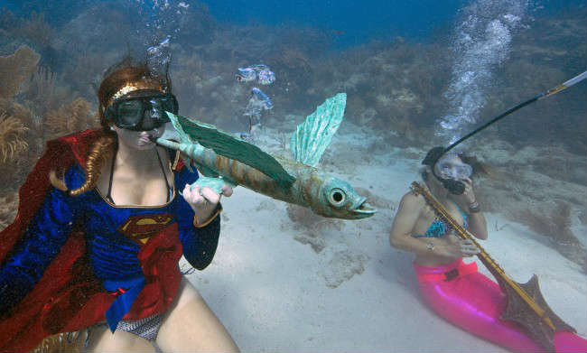 Woman Playing Instrument Underwater