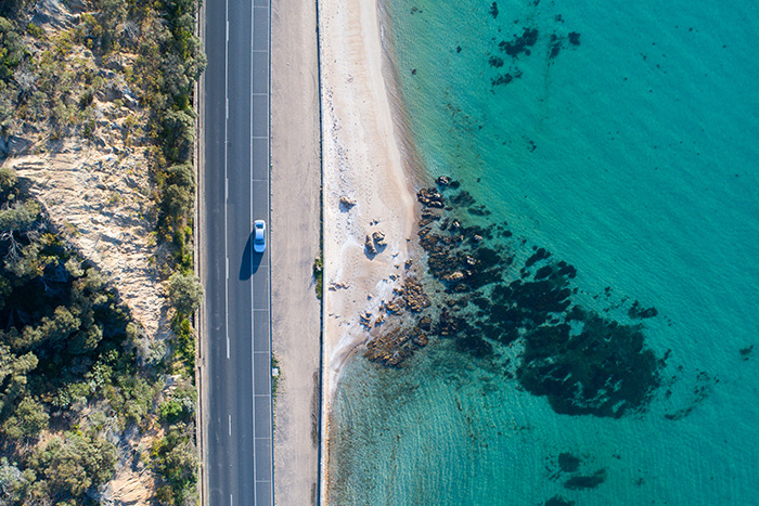 Aerial view of car on coastal road