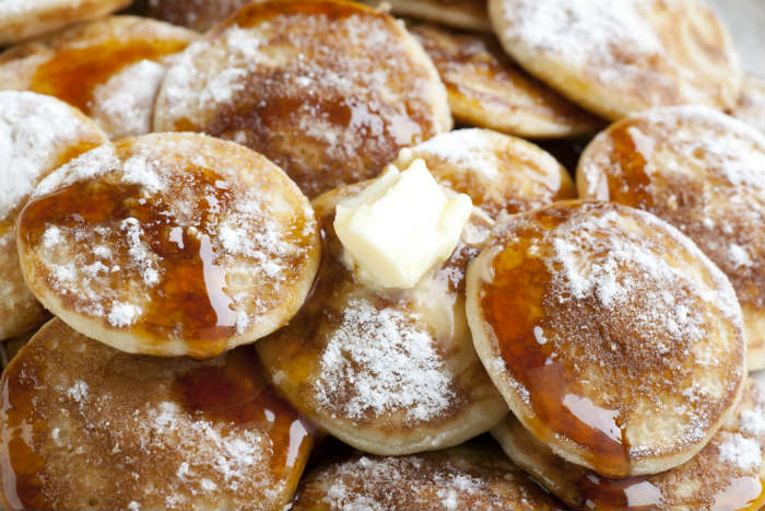 Poffertjes in The Netherlands with icing sugar and syrup